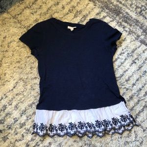 navy blue top with a floral design at the bottom.
